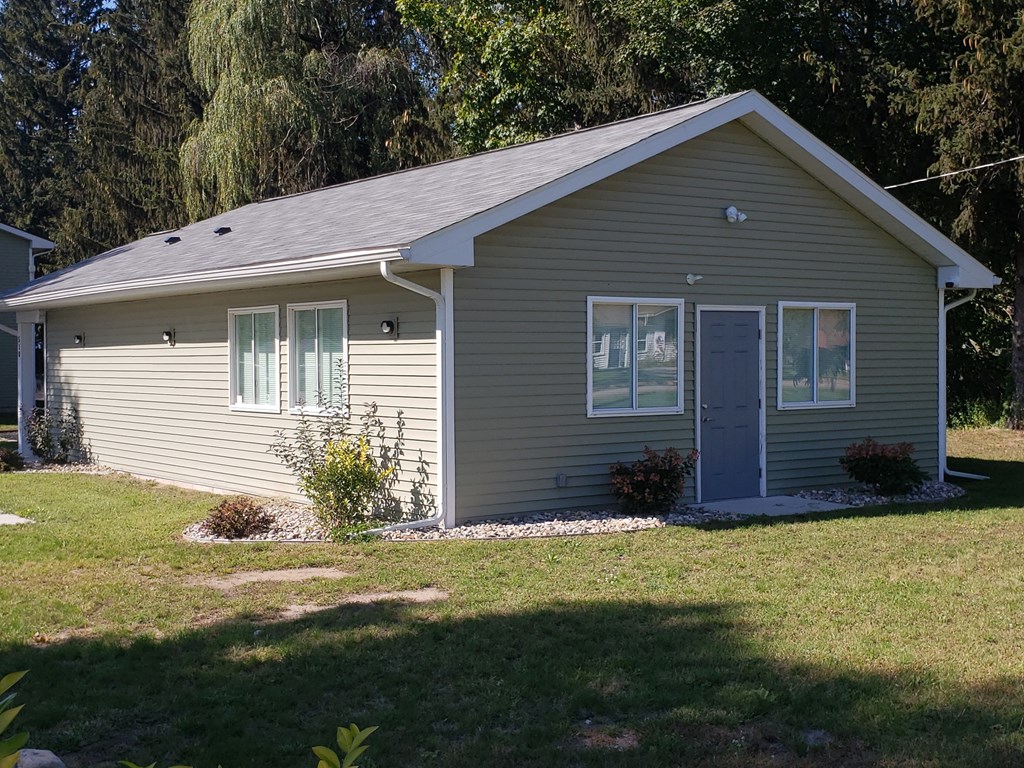 a home with a gray siding and a blue door