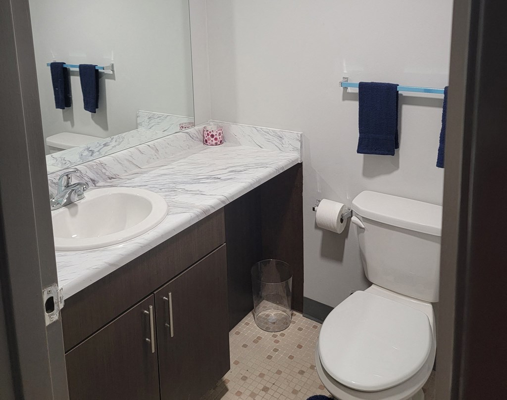 a small bathroom with a toilet sink and mirror