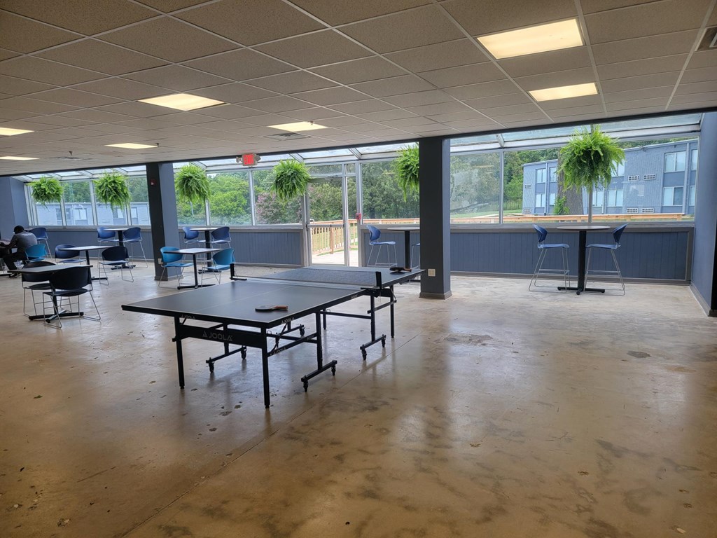 a large room with tables and chairs in a cafeteria