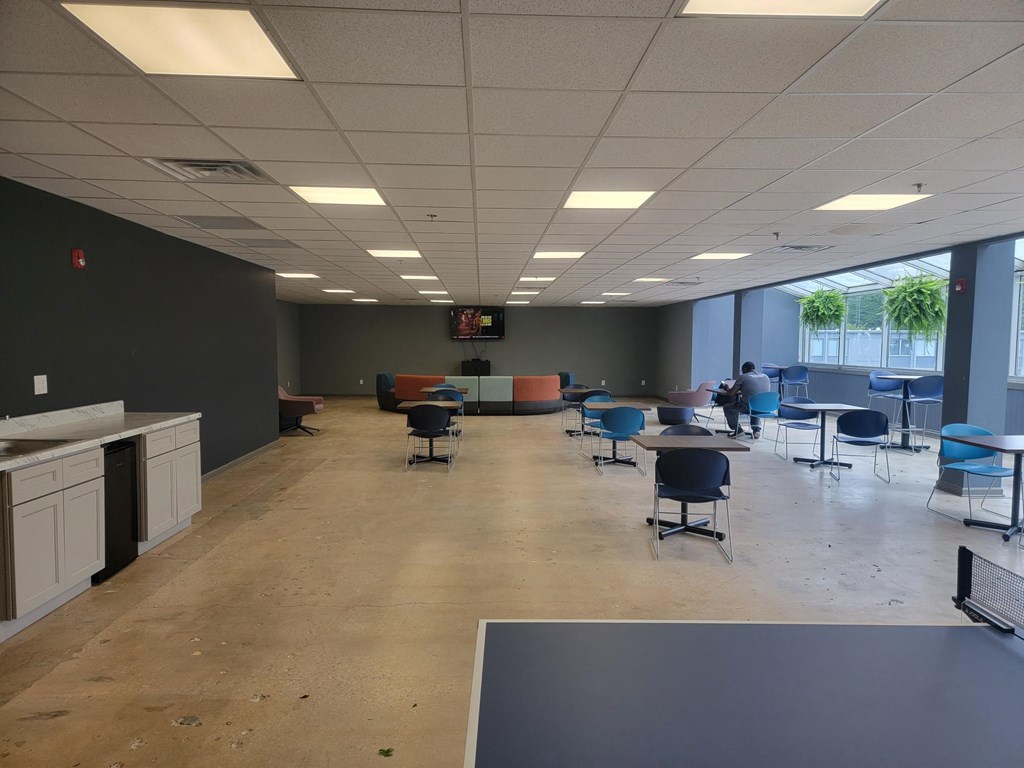 a large room with tables and chairs and a table and chairs