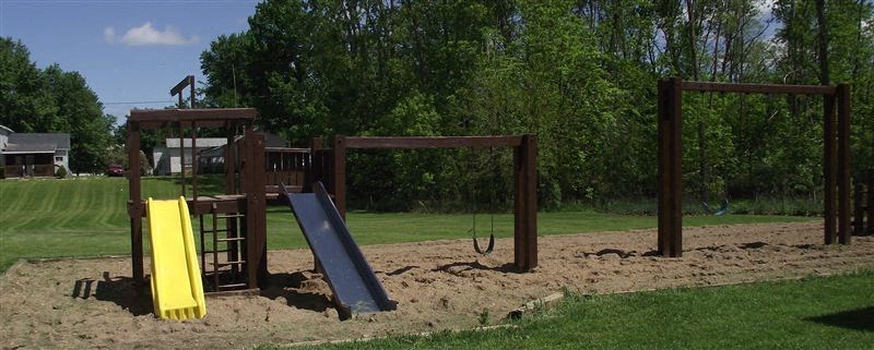 a playground with a slide and a swing set
