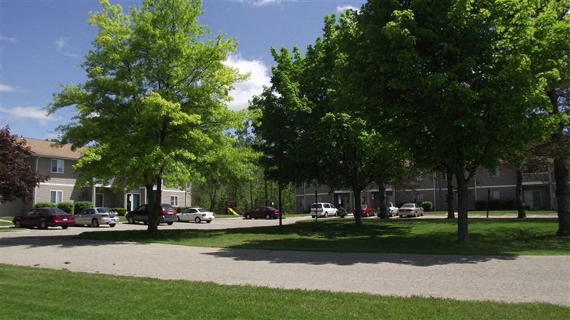 a street with cars parked in front of a building
