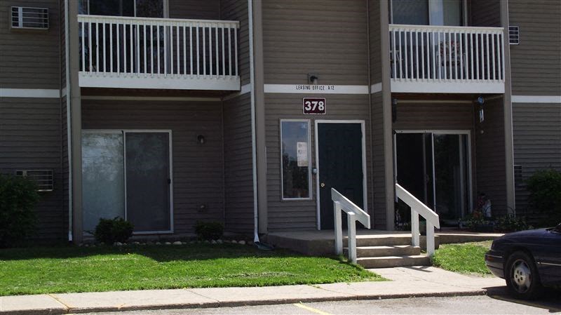 the front of a building with stairs and a door