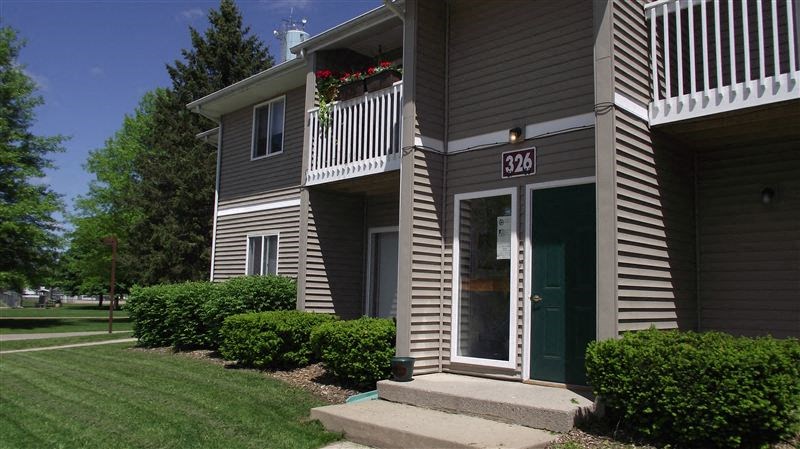 a house with a porch and a green door