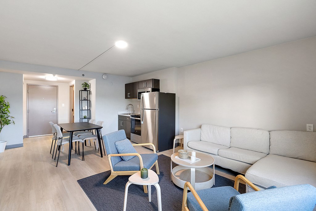 a living room and kitchen in a 555 waverly unit at The Block at Sterling Heights, Sterling Heights, MI, 48312