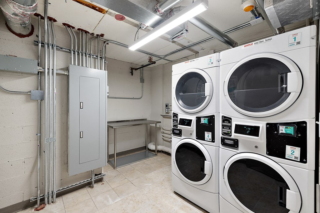 a washer and dryer in a laundry room at The Block at Sterling Heights, Sterling Heights, Michigan