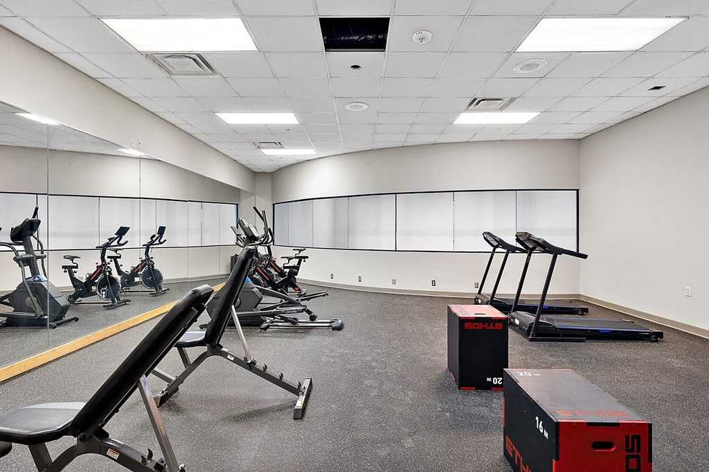a large exercise room with treadmills and other exercise equipment at The Block at Sterling Heights, Sterling Heights, 48312