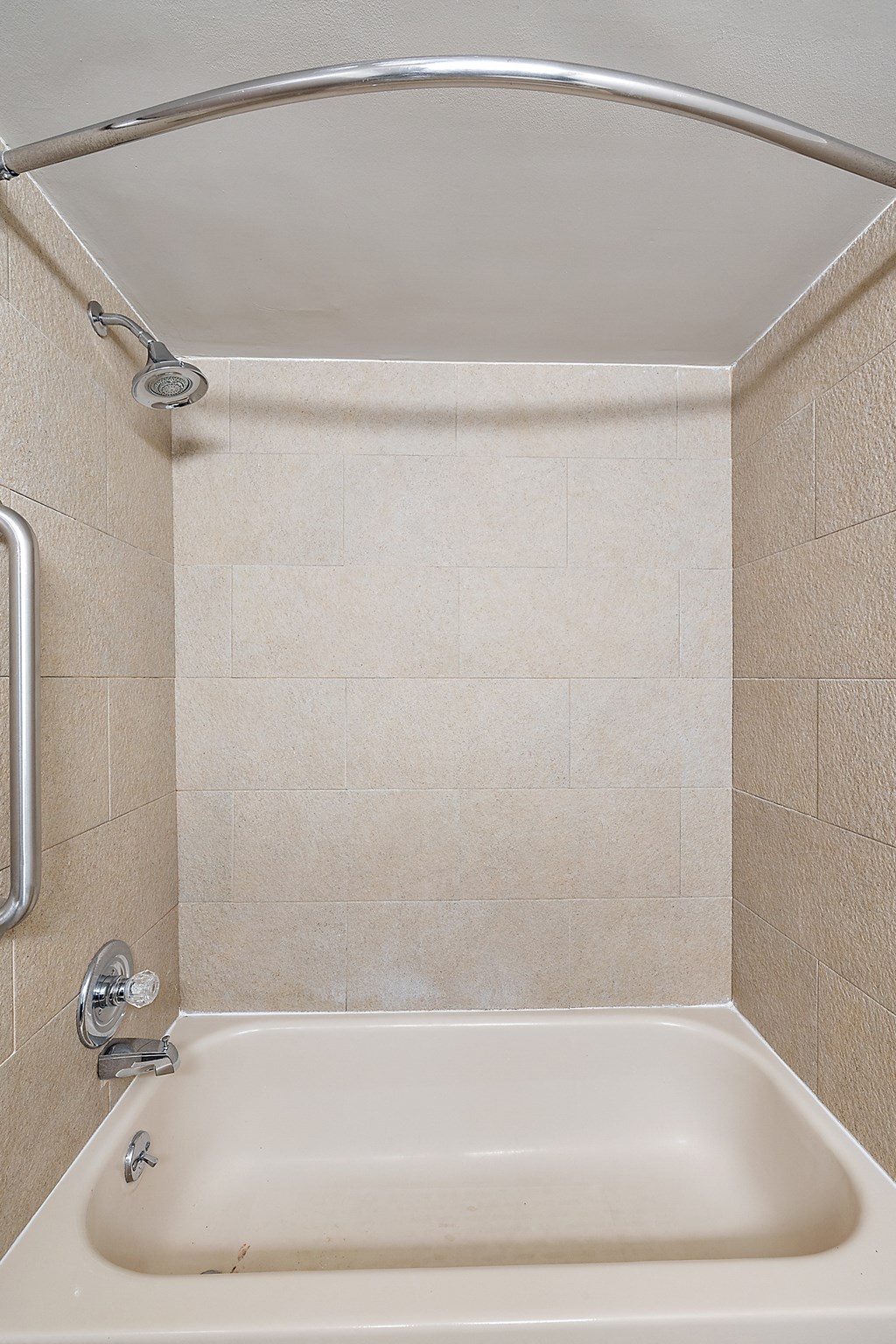 a small bathroom with a shower and a bath tub