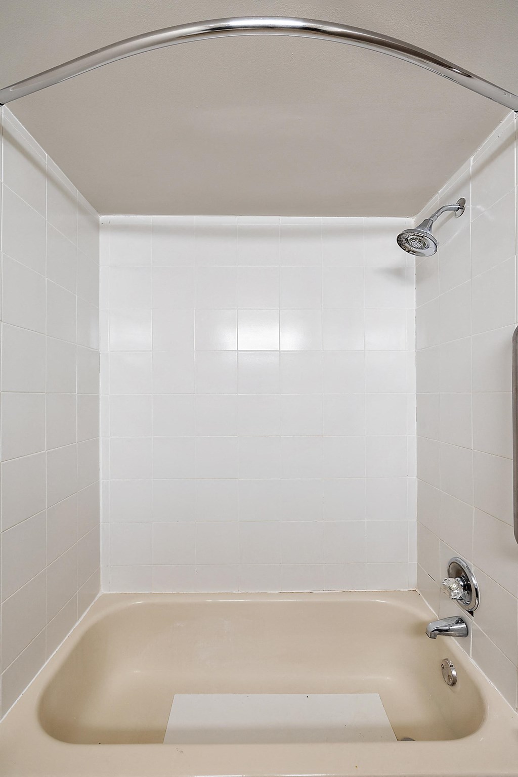 a white bathroom with a tub and a shower curtain