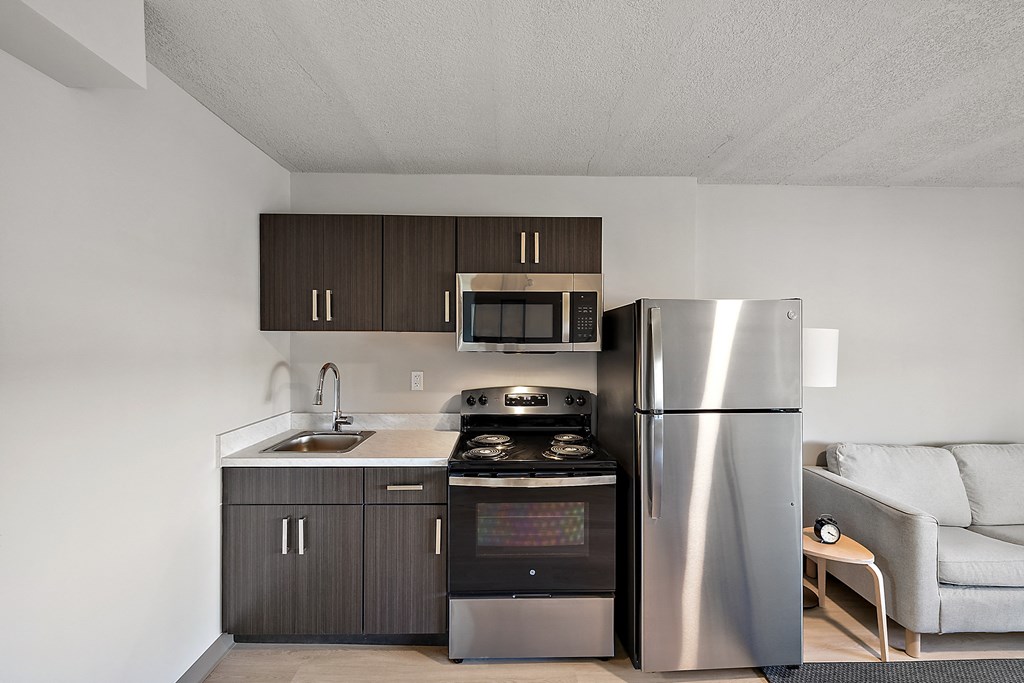 a kitchen with stainless steel appliances and a refrigerator