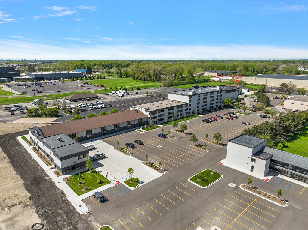 an aerial view of a parking lot and buildings in a city