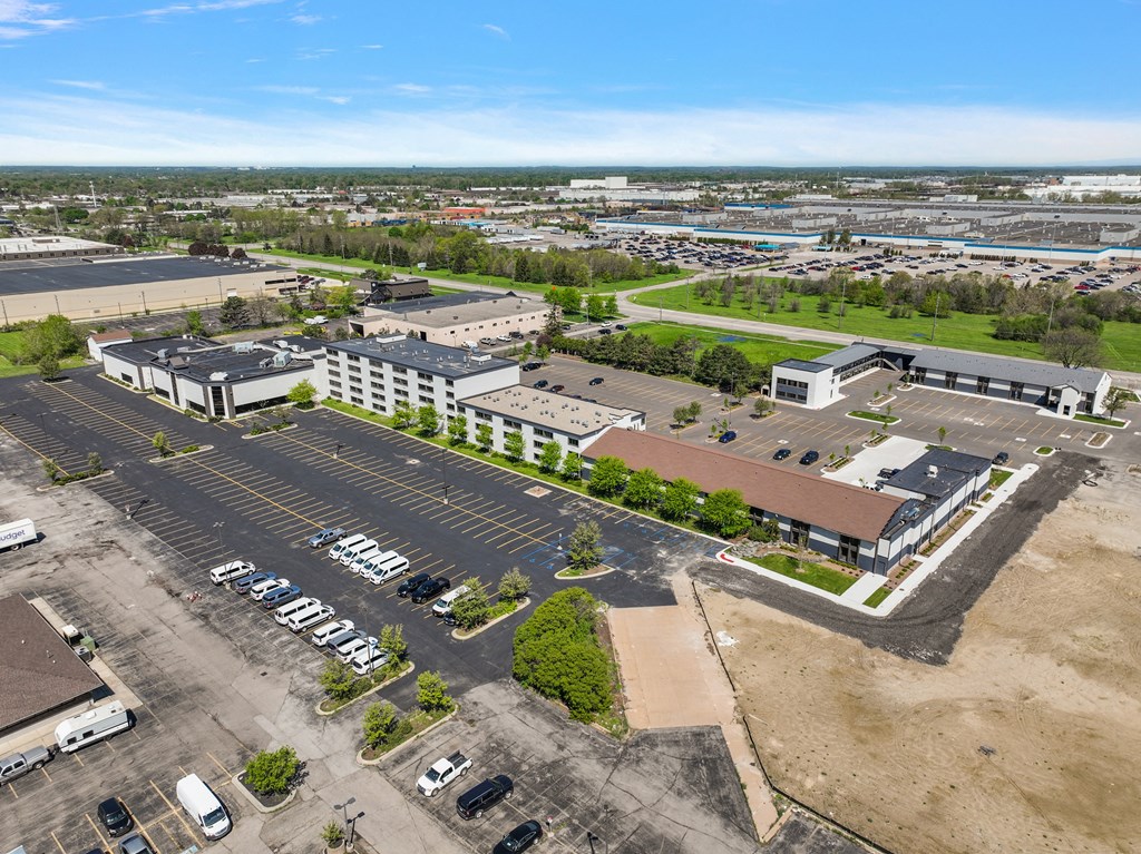 an aerial view of a parking lot and a building in the city