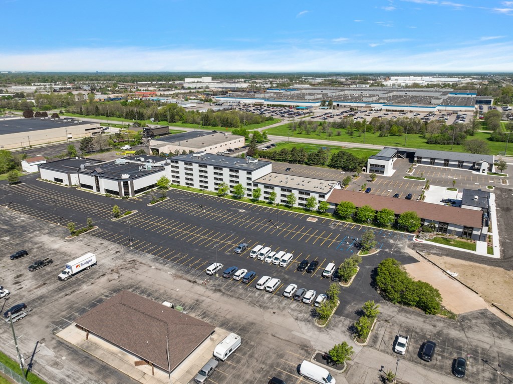 an aerial view of a parking lot and buildings in a city