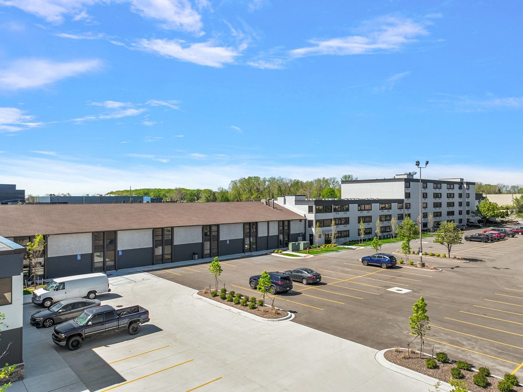 a parking lot with cars in front of a building