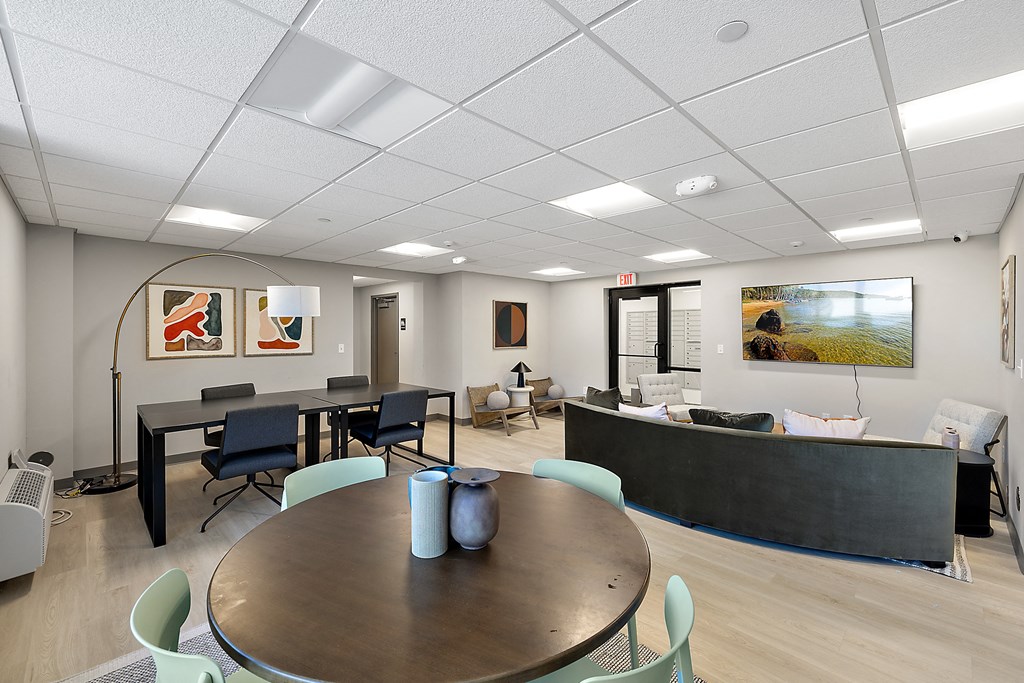 a conference room with a table and chairs and a couch