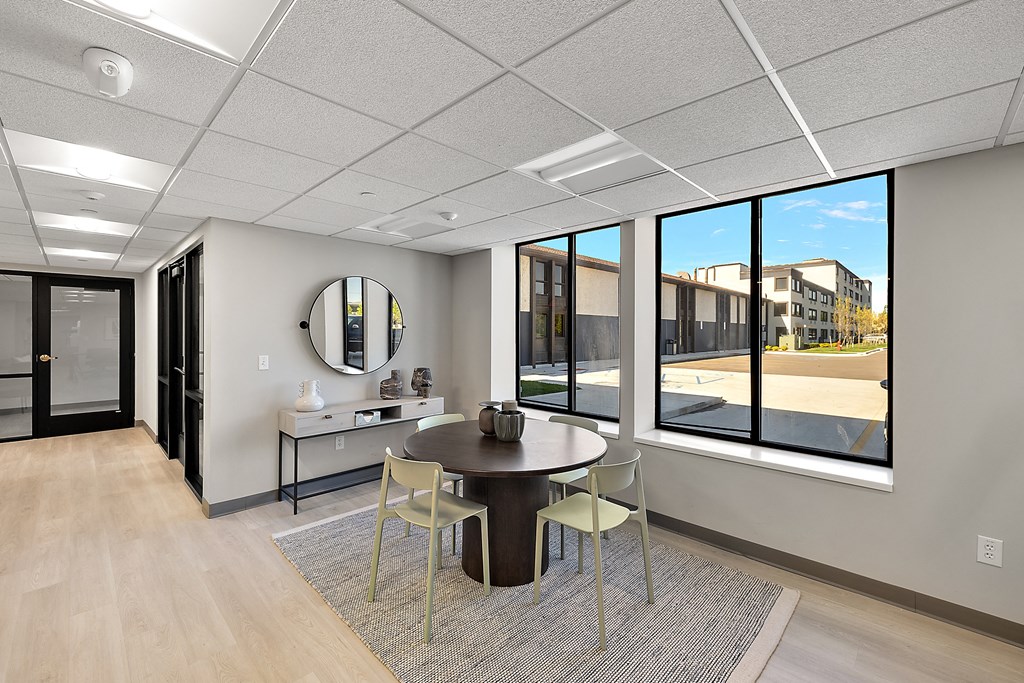 a conference room with a table and chairs and a large window