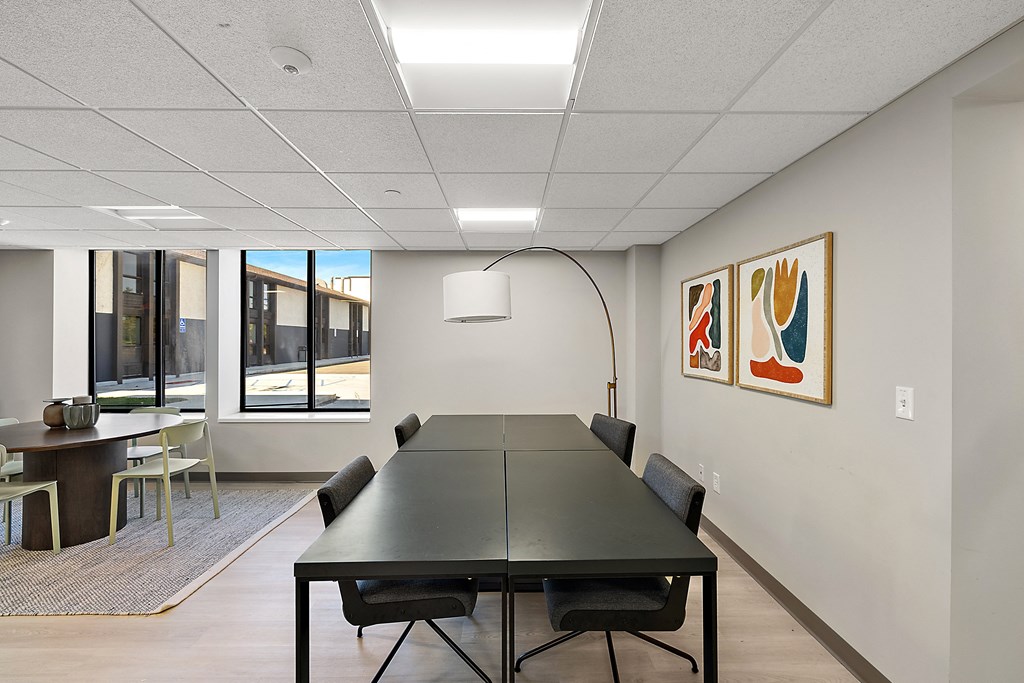 a conference room with a black table and chairs