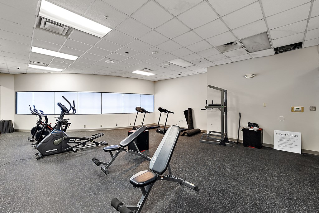 a gym with various exercise equipment in a large room