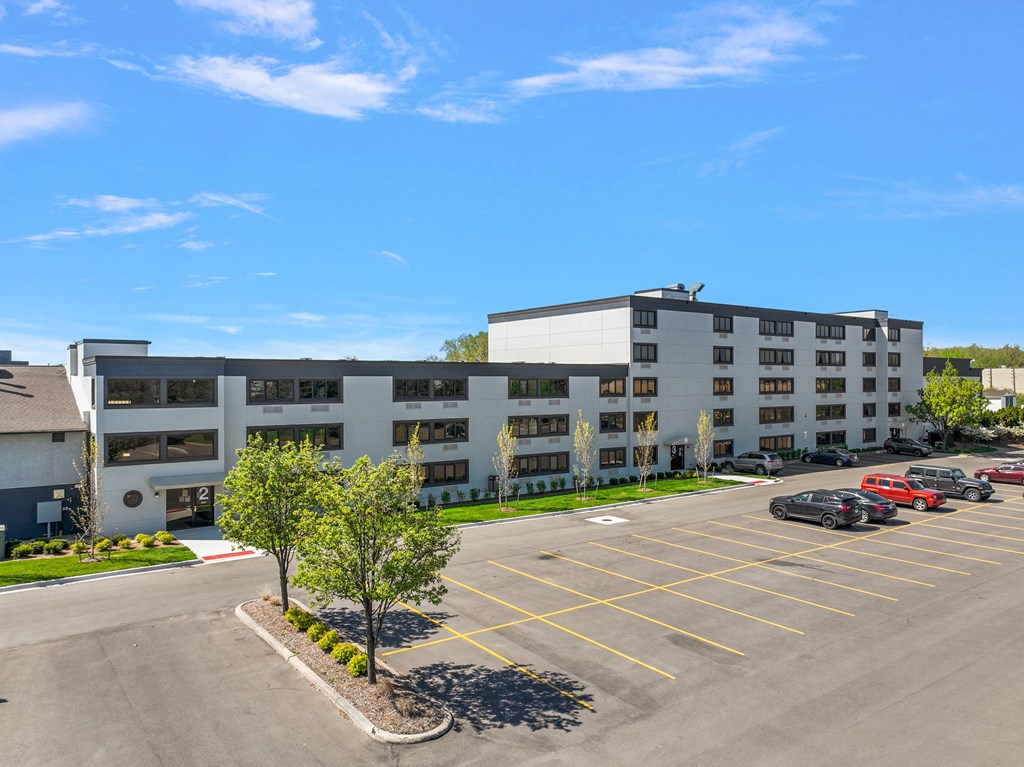 a parking lot in front of an apartment building
