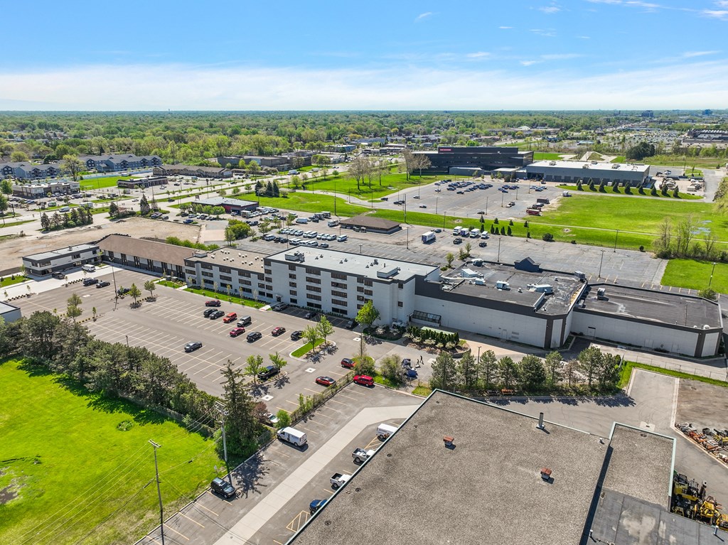 an aerial view of a parking lot in a city with buildings