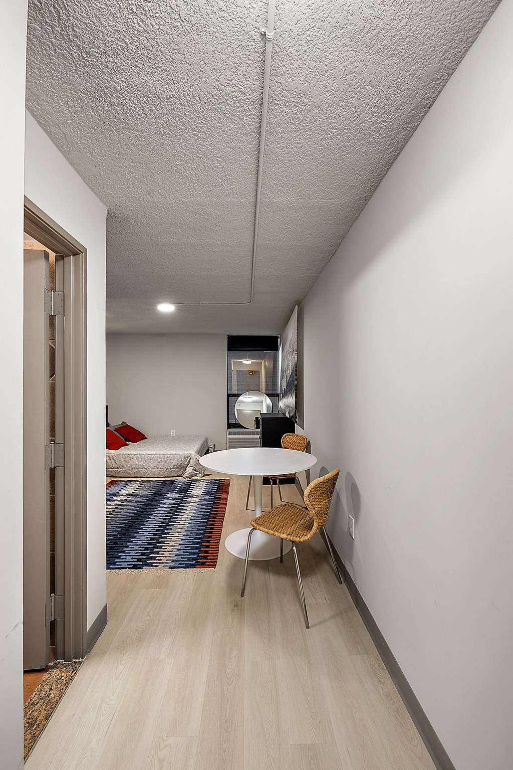 a small room with a bed and a table and chair