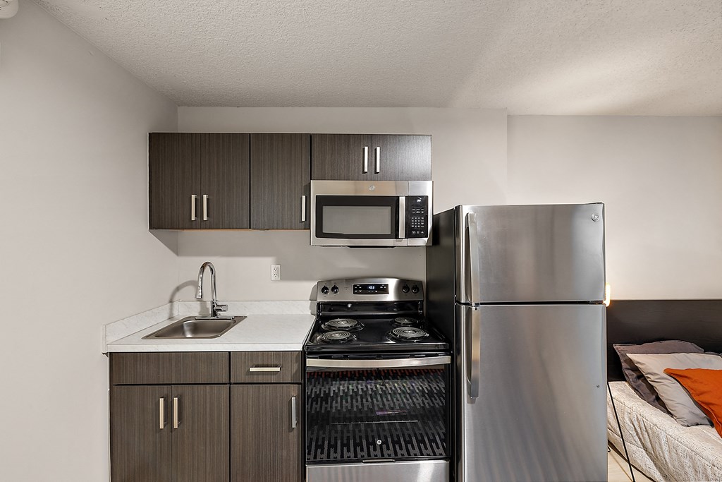 a kitchen with stainless steel appliances and a refrigerator