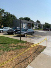 a parking lot with cars parked in front of a building