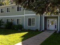 a blue house with a sidewalk in front of it