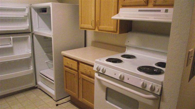 a kitchen with a stove and a refrigerator