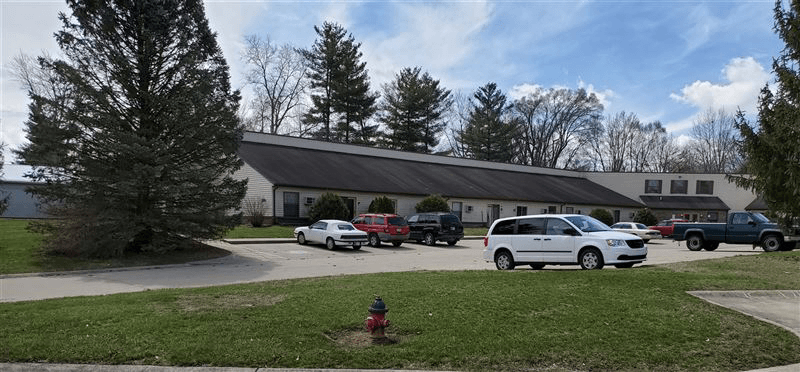 a house with cars parked in a parking lot