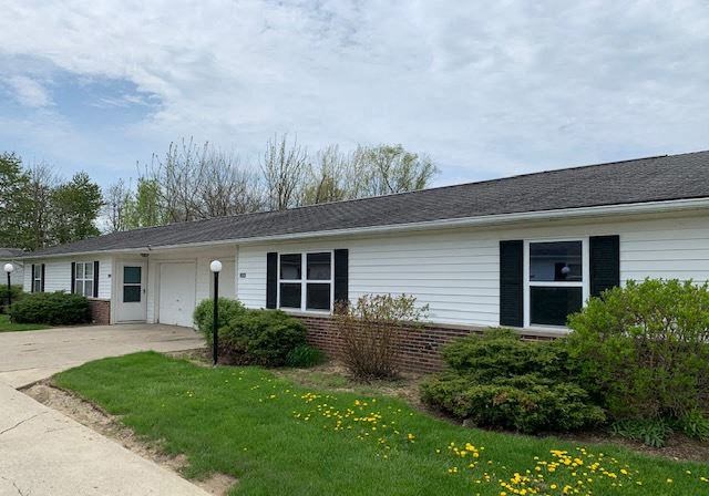 a white house with a sidewalk in front of it