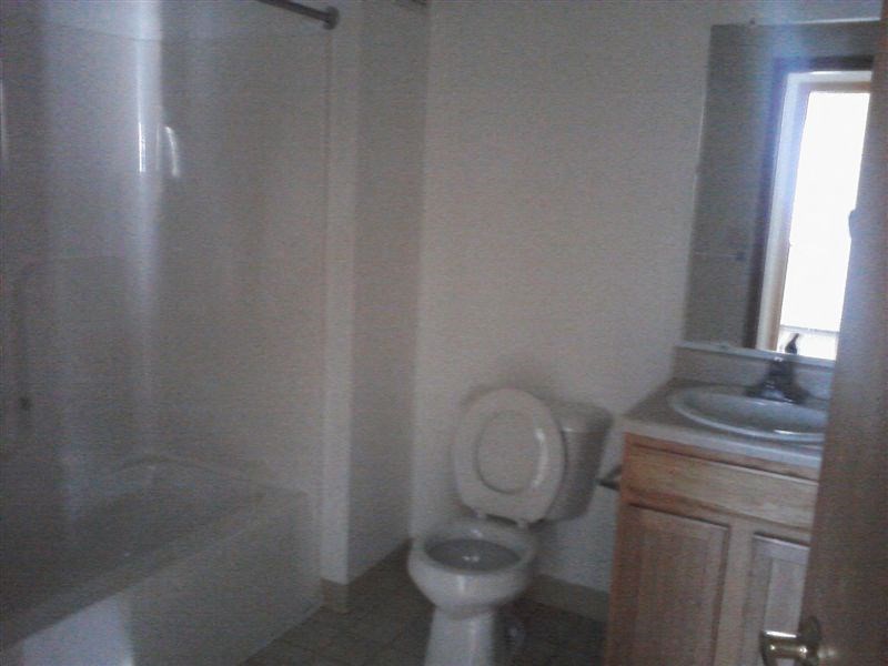 a bathroom with a toilet and a sink and a bath tub