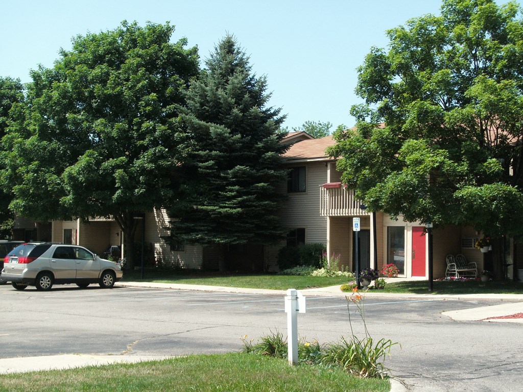 an apartment complex with a car parked in front of it