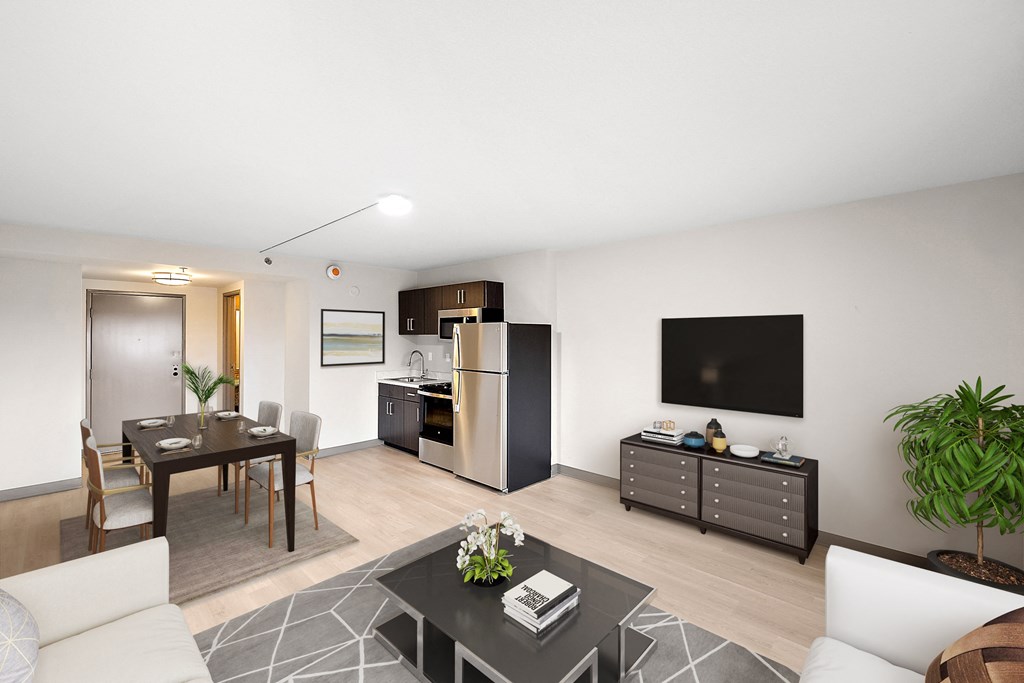 a living room and kitchen in a one bedroom apartment at The Block at Sterling Heights, Sterling Heights, Michigan