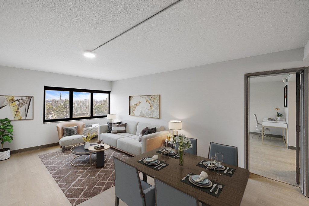 a spacious living room with a dining room table and chairs at The Block at Sterling Heights, Sterling Heights, MI