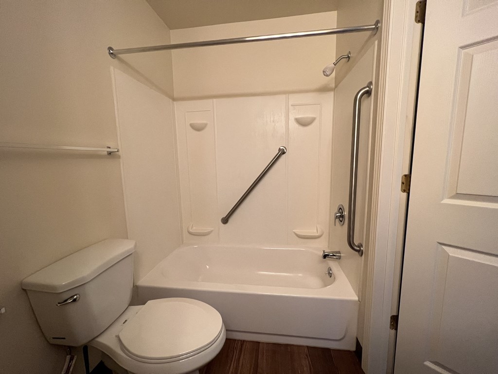 a small bathroom with a toilet and a bathtub
