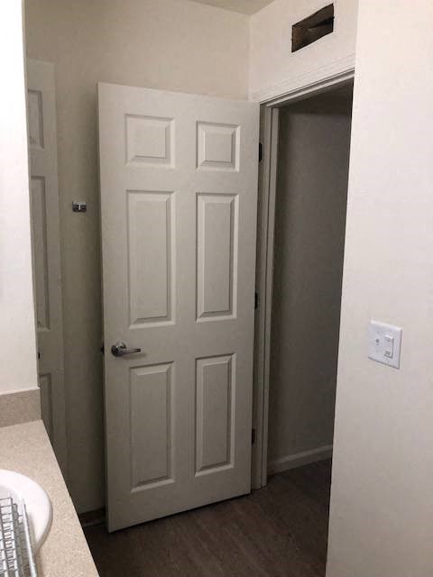 a bathroom with a white door and a closet