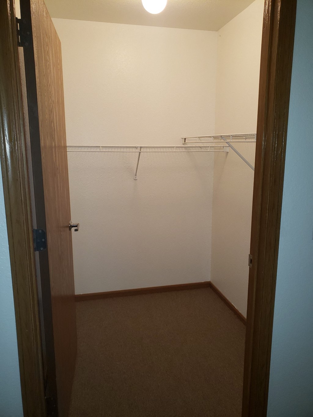 a walk in closet in a bedroom