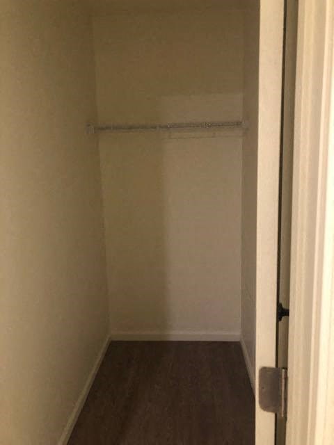 a small room with a closet and a door