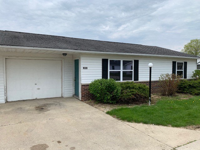 a white house with a white garage door and a driveway