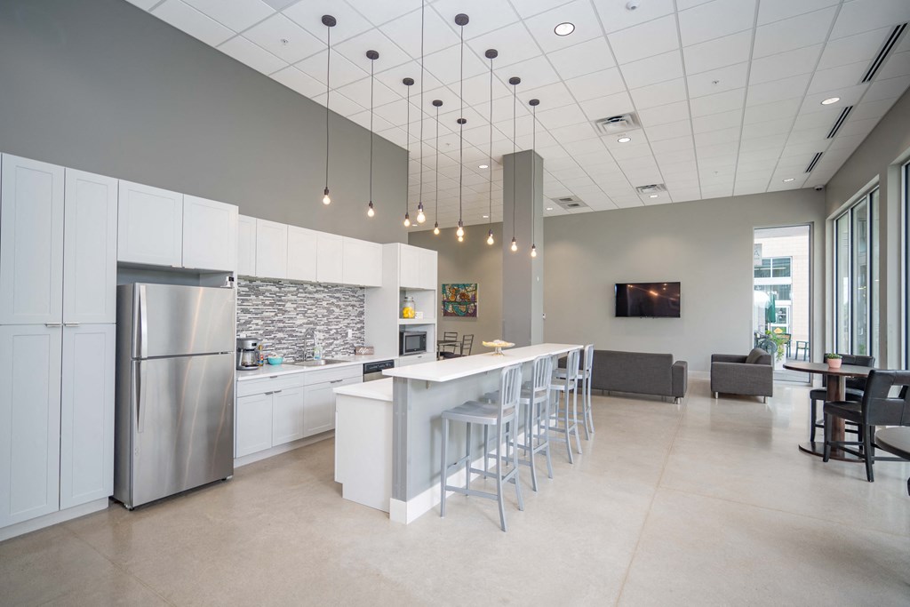 a kitchen with white cabinets and a long island with a white countertop