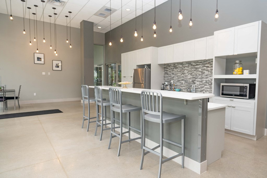 a kitchen with white cabinets and a long island with a white countertop