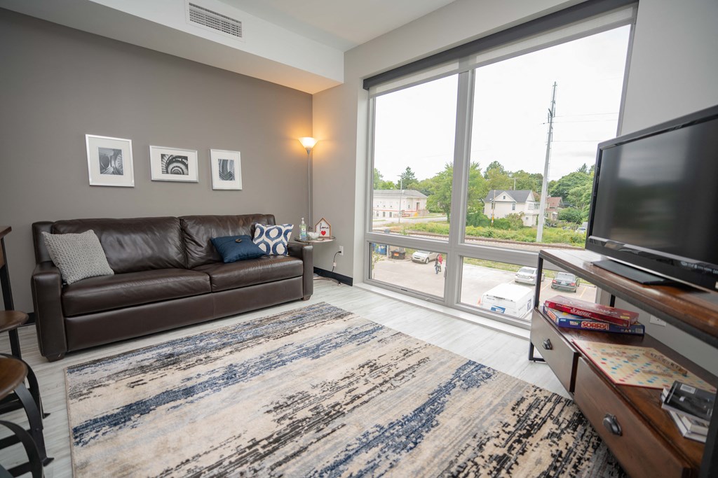 a living room with a large window and a couch