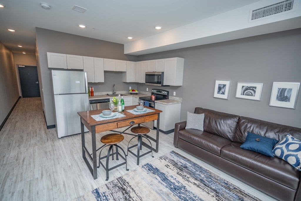a kitchen and living room with a couch and a table