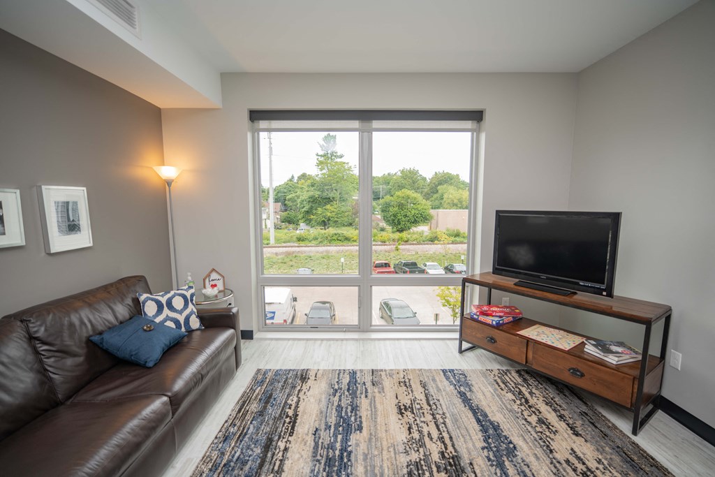 a living room with a large window and a couch