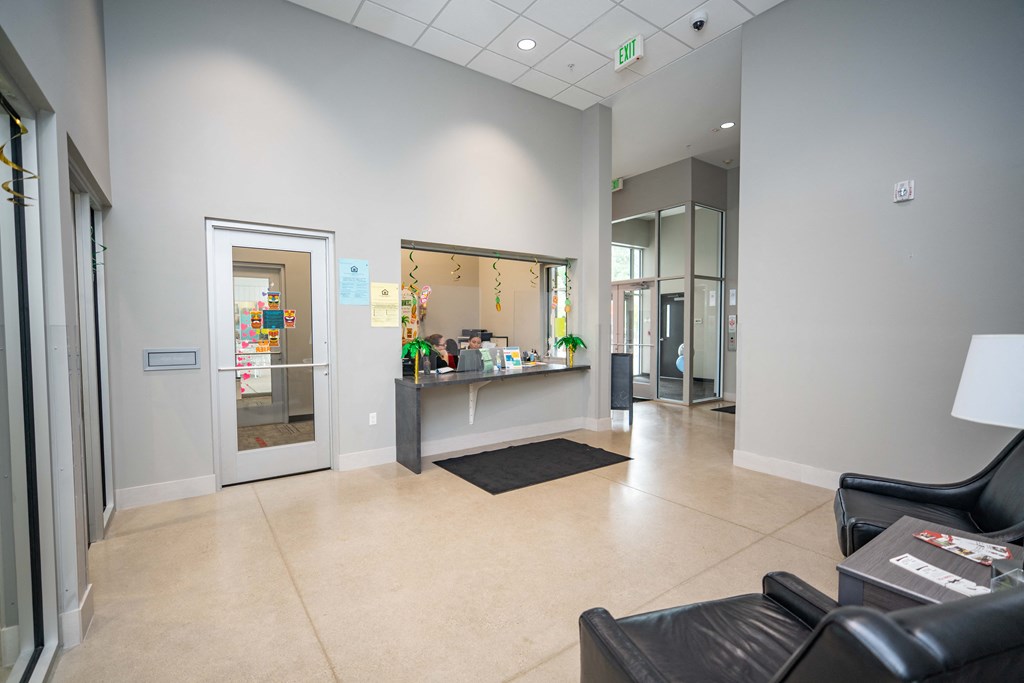 a reception area with a reception desk and a glass door