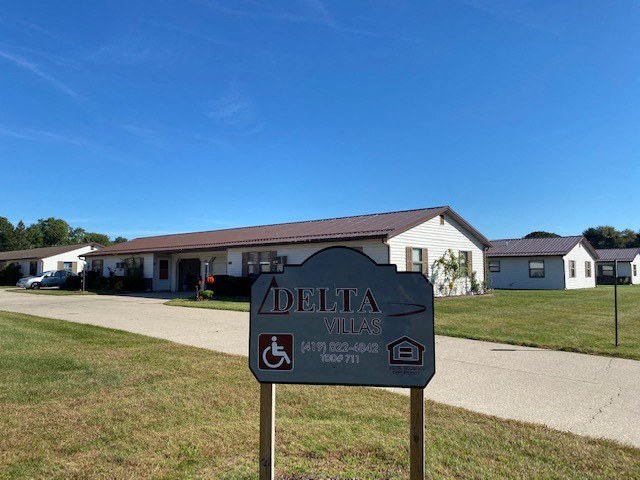 a sign in front of a house
