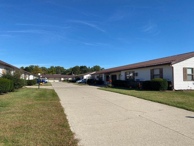 a sidewalk in front of a row of houses