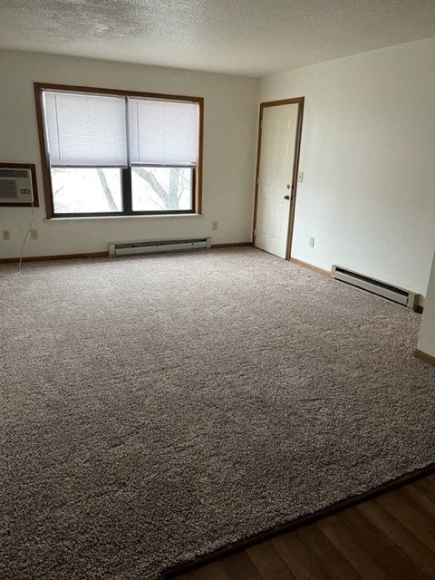 an empty room with a window and a door