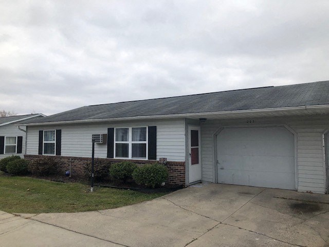 a white house with a driveway and a white garage door